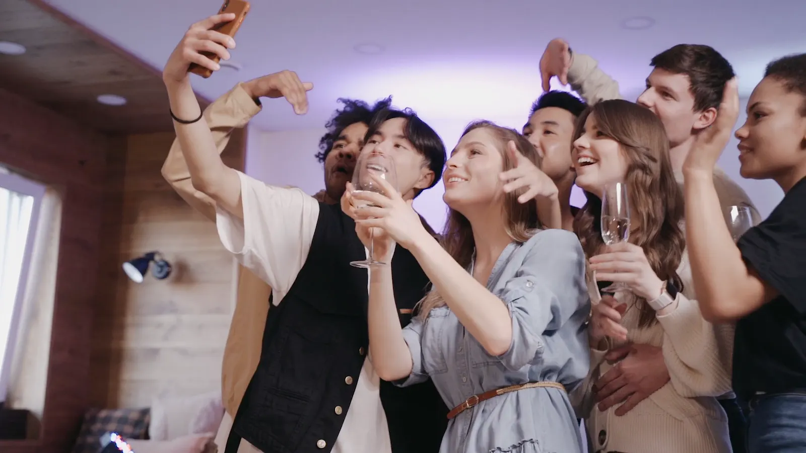 A crowd of friends crammed into one selfie at a party